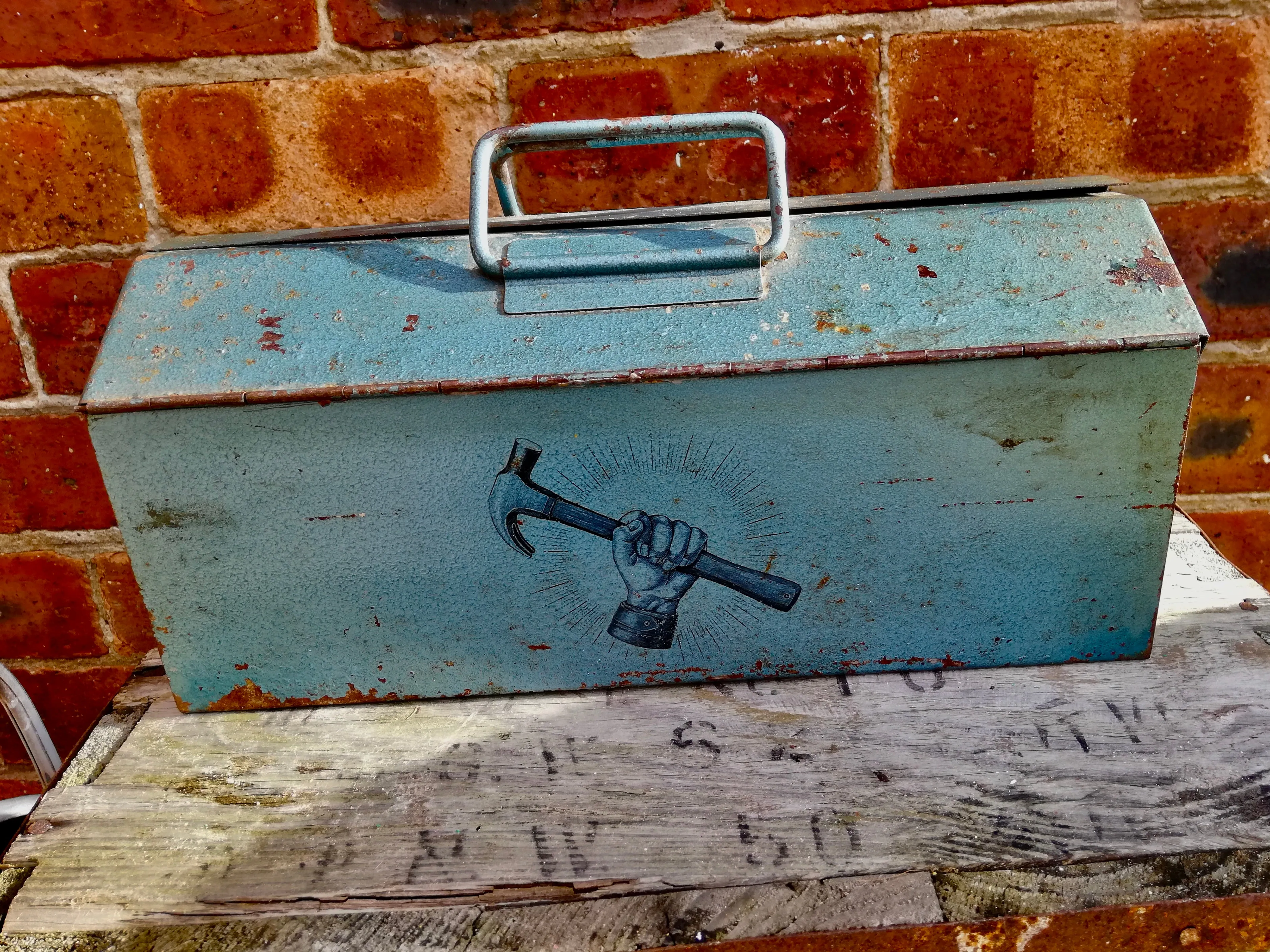 Vintage blue metal tool box with hammer design